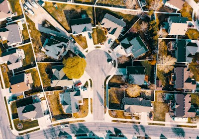 A straight-down aerial view of a cul-de-sac, the road running in from the bottom of the frame to a circular turnaround with houses fanned around it and their driveways meeting the circle