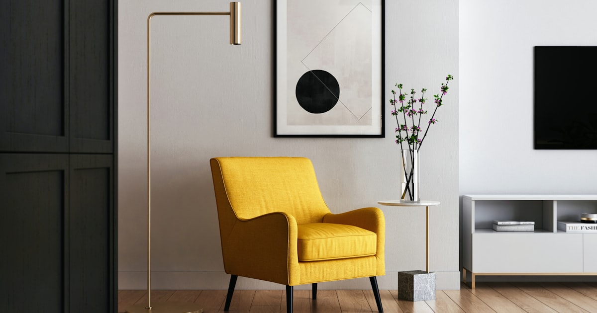 A yellow armchair set against a wall, facing into a bright living room
